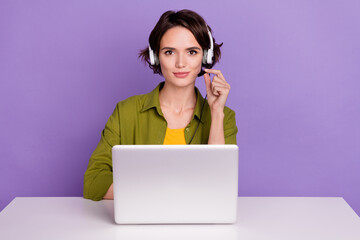 Photo of young lovely girl manager help line earphone speaker laptop sit table isolated over violet...