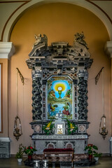 Shkoder, Albania - June 21, 2021: Religious paintings on the wall inside St. Stephen Cathedral in Shkoder, vertical. Modern design of the interior of the catholic church
