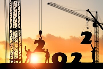 Silhouette staff works as a to prepare to welcome the new year 2022 on construction site