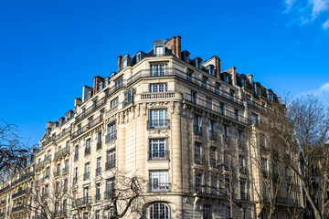 Paris, beautiful buildings, place Denfert-Rochereau in the 14e arrondissement, blue sky in winter

