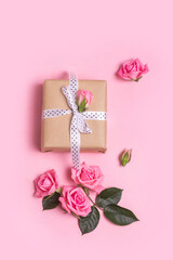 Craft gift box on pink background with pink roses . Valentine's Day. Mother's Day.