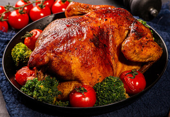 grilled chicken with vegetables on a dark background