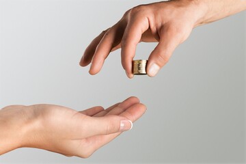 Businessman giving golden bitcoin to another human. two hands exchanging cryptocurrency.