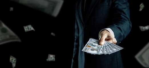 American cash. Business man hand holding dollar sign. Usd bill money falling banner.