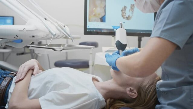 Orthodontist using 3D intraoral scanner for scanning teeth patient's. Modern dental clinic with equipment. Dentistry and health care concept. Jaw scan, digital imprint, medical digital technology.