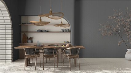 Modern dining room interior in country apartment, cream and gray tones, craft wooden table, rattan chairs, molded concrete walls with shelves. Design background with copy space