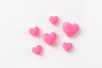 3d pink hearts creative arrangement on white background. Concept of love, romantic relationship, heart shape symbol, simple layout, celebration of  Valentine's Day, wedding background.