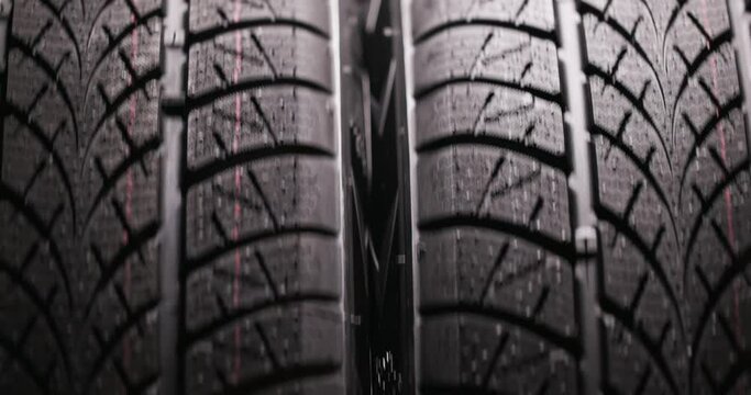 Clean car tyres spinning against dark background