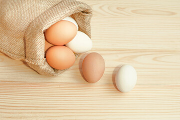 chicken eggs in a bag on a wooden table. High quality photo