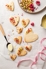 Fototapeta na wymiar Cookie hearts with raspberries. Background for Valentine's Day. Nut cookies. Baking for lovers.