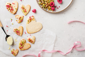 Fototapeta na wymiar Cookie hearts with raspberries. Background for Valentine's Day. Nut cookies. Baking for lovers.