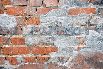 Old brick wall texture with cracked peeling paint. Abstract grunge backdrop