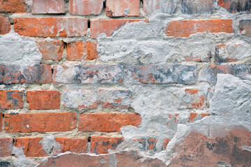 Old brick wall texture with cracked peeling paint. Abstract grunge backdrop