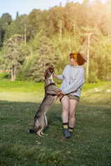 Young caucasian woman training her dog