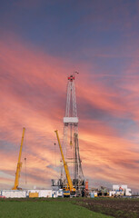 Obraz premium oil drilling rig and cranes petrochemical industry