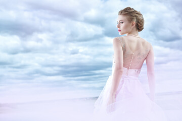 Fototapeta na wymiar gorgeous bride against the sky