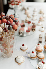 the wedding candy bar is filled with different desserts. wedding table at the banquet