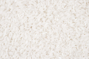 White long rice background, uncooked raw cereals, macro closeup