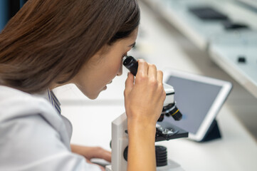 Close-up of womans face looking through microscope