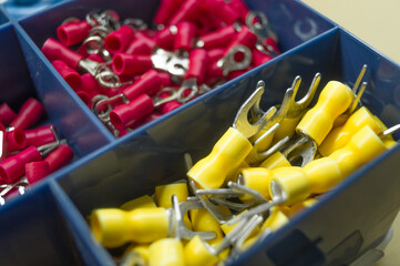A set of colored crimp terminals for electrical wires. Crimping sleeves of different sizes. Plastic...