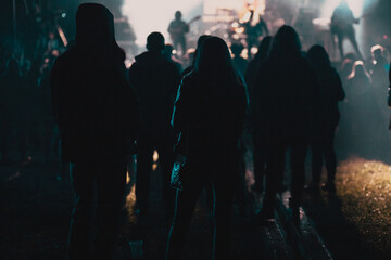 crowd at concert and silhouettes in stage lights