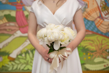 Obraz na płótnie Canvas Bride with wedding bouquet, closeup