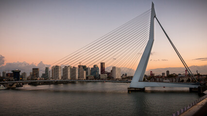 Erasmus Bridge in Rotterdam at sunset with the Rotterdam skyline.