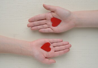 Valentine's day , 14 february .Declaration of love . valentine , two hearts . Valentines in the shape of a heart in hand .