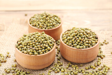 Soy beans with bowls on wooden background