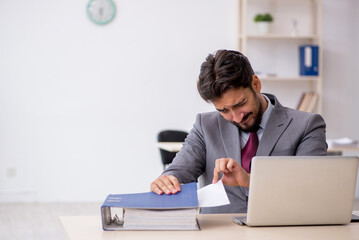 Young male employee working in the office