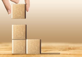 Businessman holding the wooden cube. Goals and planning for success in marketing business