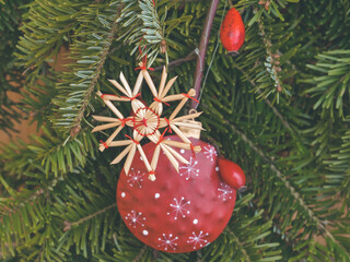 christmas door decoration with handmande straw star and bauble