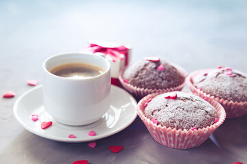 Cup of coffee, chocolate muffins and gift.