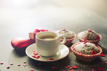 Cup of coffee, chocolate muffins and gift.