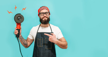 Bearded builder portrait with angle grinder in his hands. Repair service and construction concept.