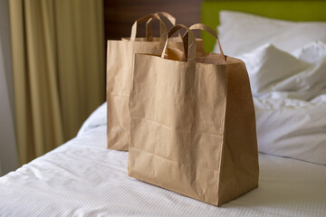 Delivery food craft bags on the bed on sunny day. Delivery in any weather around the clock to the...