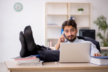 Young male employee working in the office