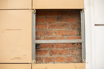Hole in wall. Facing tiles. Wall construction. Details of old building.