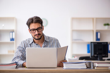 Young male employee sitting in the office