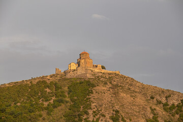 Obraz premium Panoramic view of Mtskheta Jvari monastery in Georgia. View to mountain hill with ancient walls. Famous orthodox monastery in the mountain. Ancient monastery on the hill.Travel concept.