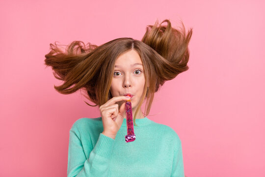 Photo of pretty school girl dressed teal pullover blowing whistle hair flying isolated pink color background