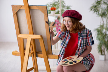 Young girl enjoying painting at home