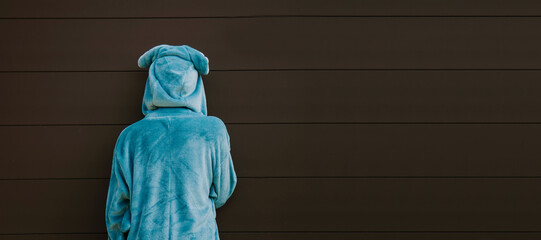 boy in costume facing wall with copy-space