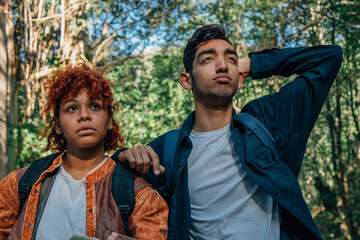 young couple traveling or hiking looking at the horizon exhausted