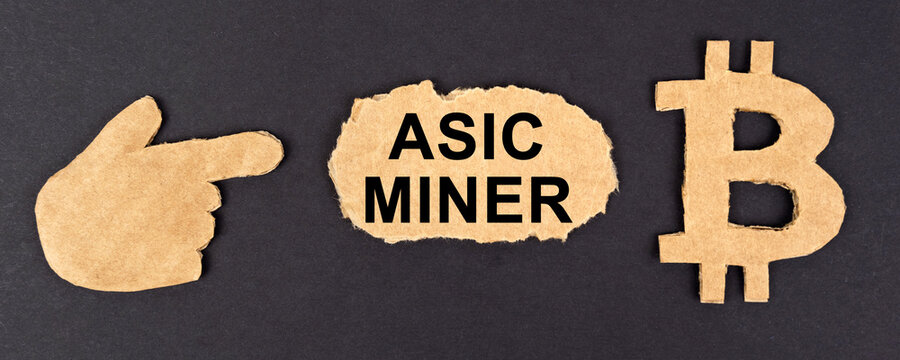 On a black background, cardboard figures of bitcoin and a hand pointing to a sign with the inscription asic miner