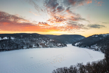 Aerial drone panorama of spectacular sunrise over the frozen and snow-covered Cheat Lake looking upriver into the gorge near Morgantown, West Virginia