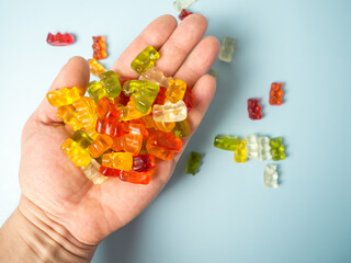 Close-up of a man holding colorful gummy bears