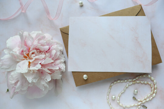 postcard mockup. bouquet of pink peonies on a pink background and space for text 