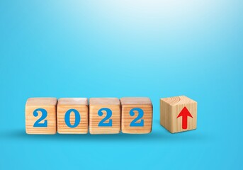 Wooden blocks with new year 2022, arrow up icons, Business development and growth concept