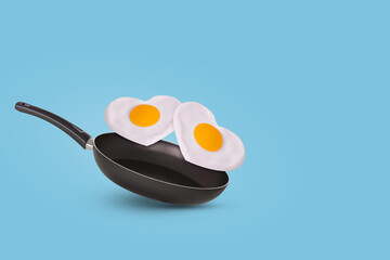 Creative idea with a frying pan and a two fried eggs in heart shape on a bright blue background. Minimal food and love concept.